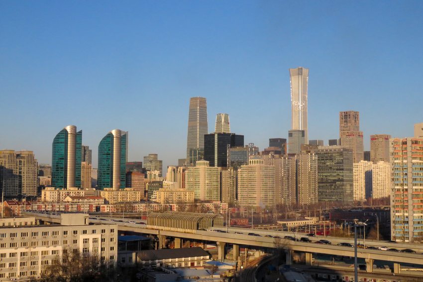 Beijing’s central business district and city buildings beneath a blue sky.