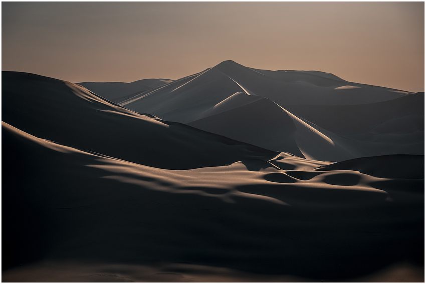 Soft sidelight tracing rolling sand dunes