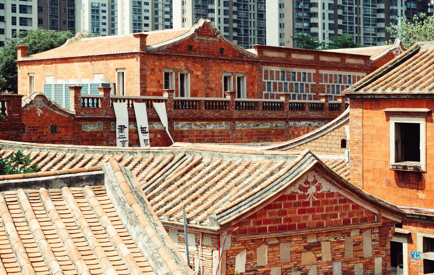 Layered red-brick buildings and traditional tiled roofs