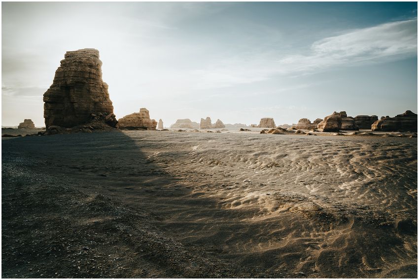 Upright rock formations and textured ground in an open desert