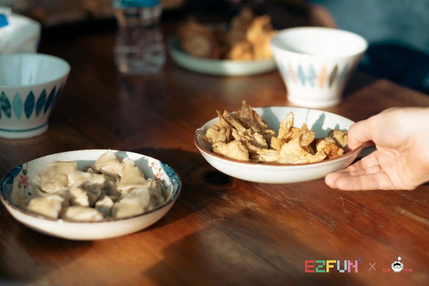 Bowls of prepared wontons are served on the table.