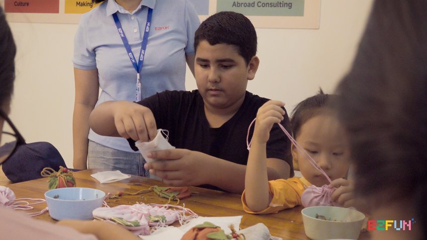 Children fill sachets and arrange their drawstrings around the table