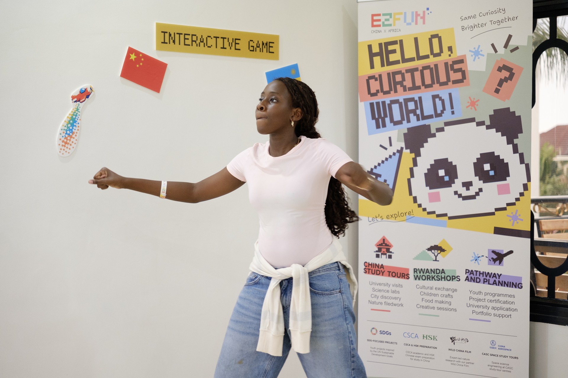 A participant tries a shuttlecock game in the interactive activity area