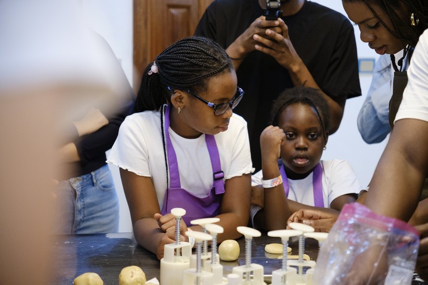 A family shares the mooncake making experience at the activity table