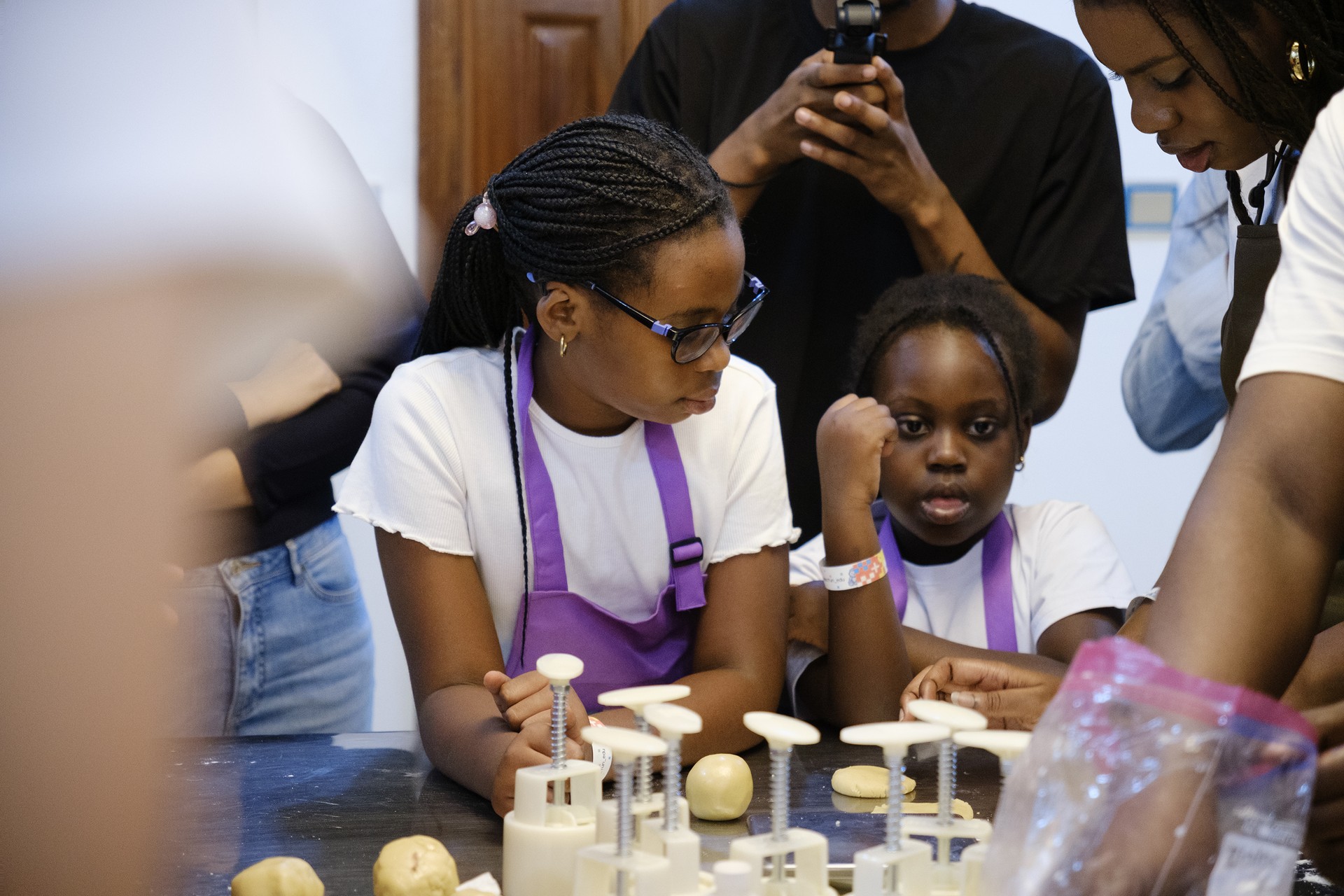A family shares the mooncake making experience at the activity table