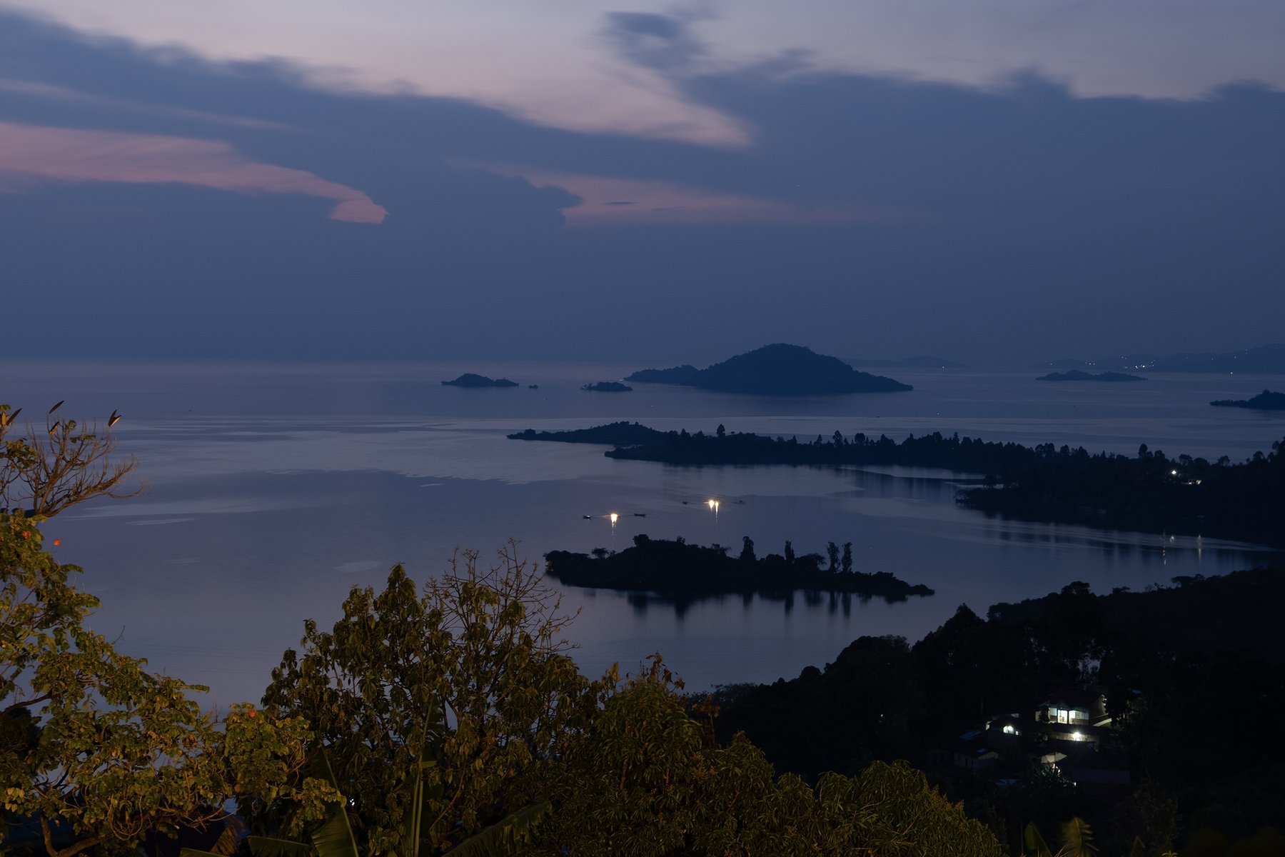 Violet-blue dusk settles over water and layered islands.
